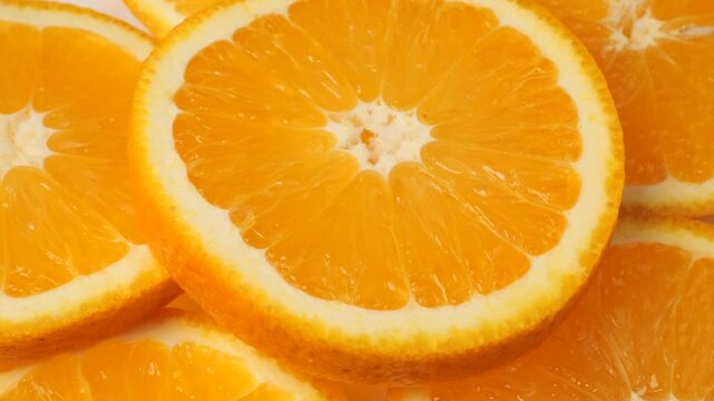 Ripe orange slices rotating as a background