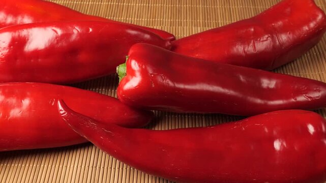 Fresh red sweet peppers on a bamboo placemat