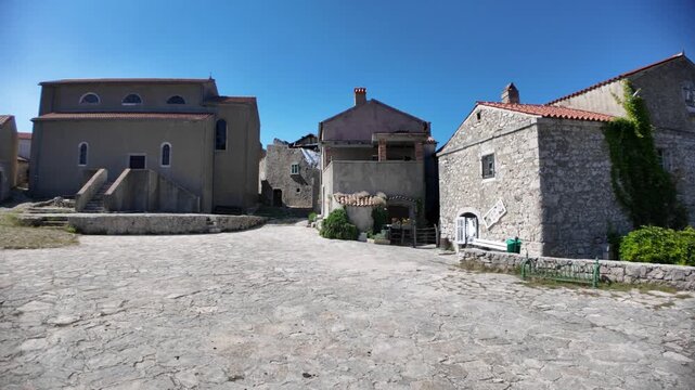 Traditional historic stone houses of Lubenice village standing on a hill overlooking the Adriatic Sea of Cres Island in Croatia. Starting point of famous trek to Sveti Ivan Beach or Lubenice Beach