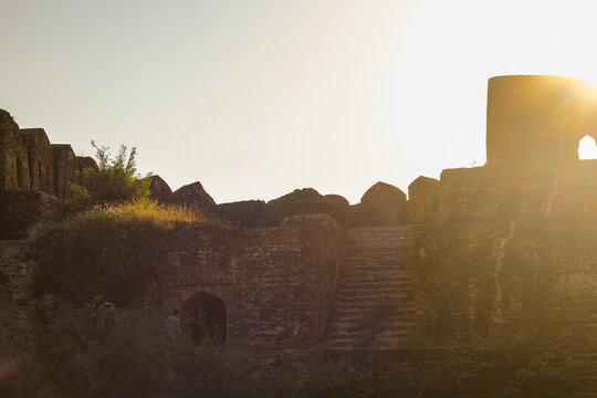 View of the historic stone walls and stairs of Rohtas Fort during golden hour in Dina, Punjab, Pakistan.