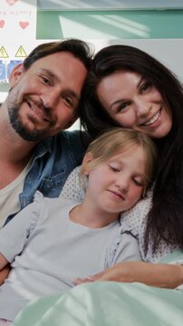 Parents embrace daughter during peaceful hospital recovery