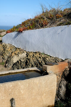 Stone water trough in the coastal countryside of Portugal