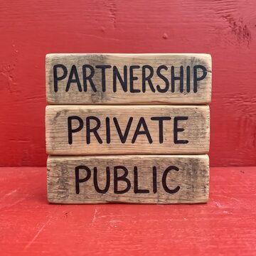 Public private partnership text on wood cubes symbolizing government and business cooperation.   