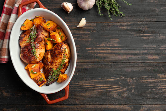 Autumn meal: roasted chicken breast and pumpkin with herbs