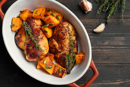 Autumn meal: roasted chicken breast and pumpkin with herbs