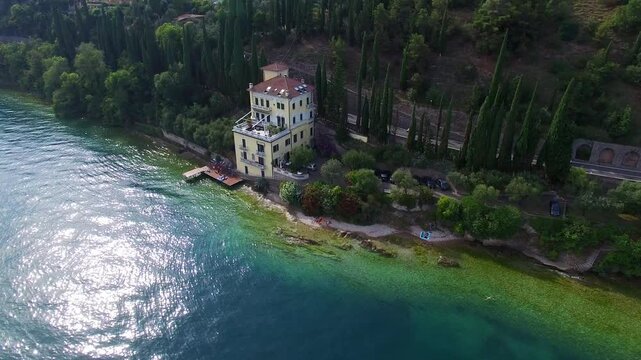 Lakeside villa above clear turquoise water at Lake Garda