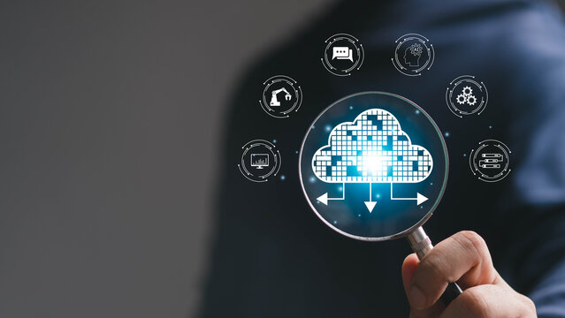 Cloud computing concept with a magnifying glass revealing a digital cloud, surrounded by AI, automation, servers, analytics, and communication icons, representing scalable technology and data services