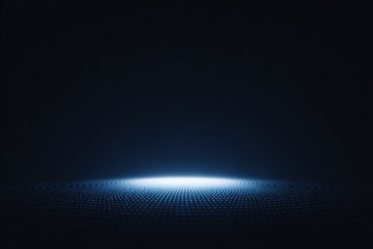 A dark background with a bright blue light in the middle creating a mesmerizing effect. the light is radiating from the center of the illuminating the darkness and creating a .