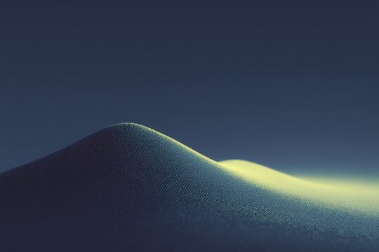 A sand dune with a blue sky in the background. the sand is a light tan color and the sky is a deep blue. the sun is shining brightly illuminating the sand and creating a contrast between the two.