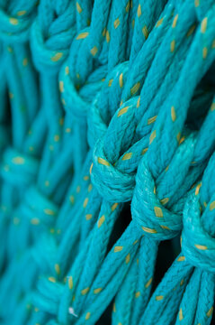 View of a textured teal fishing net with yellow flecks in Canada.