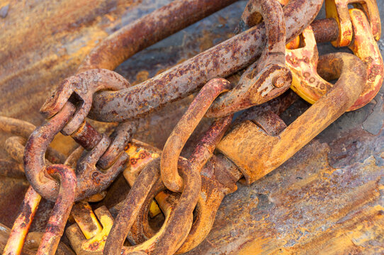 View of rusty metal chains and heavy-duty hooks used in fishing equipment in Canada.