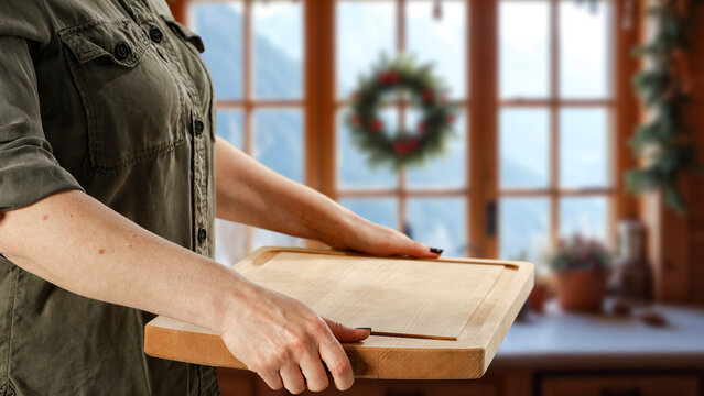 Woman holding wooden tray with copy space &ndash; cozy winter interior concept.
