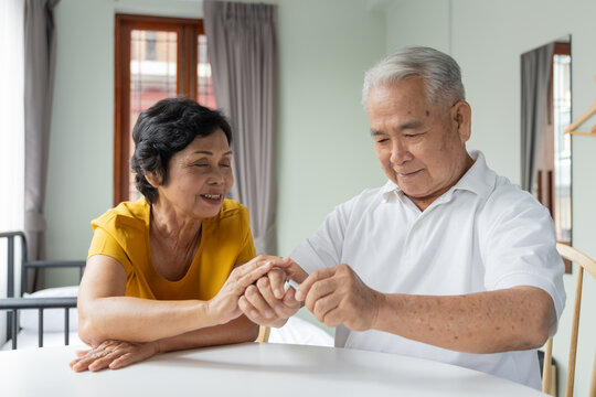 senior southeast asian couple at home, wife asking husband to quit smoking cigarette, and husband successfully make the quit smoking or stop smoking decision
