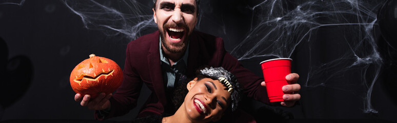 Obraz premium Multicultural couple gather for a lively Halloween party filled with joy, banner 