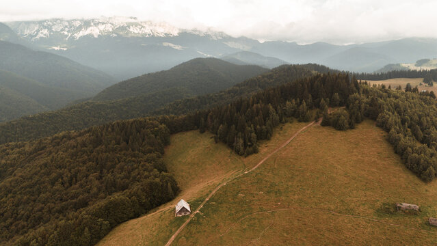 Aerial View of Wooden Mountain Hut on Alpine Meadow - Transylvania, Bucegi Mountains, Romania
