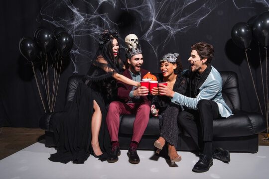 Friends celebrating Halloween in stylish costumes at a lively spooky bash