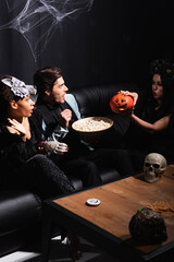 Obraz premium Friends celebrate Halloween in style at a lively costume party full of joy