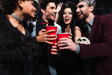 Obraz premium Multicultural friends gather for a lively Halloween costume party celebration