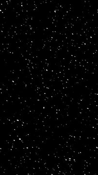 Falling snow particles on black background, vertical loop overlay