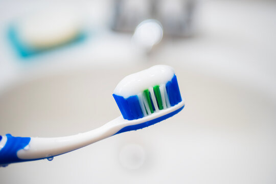 Close-up of white toothpaste squeezed onto a toothbrush head
