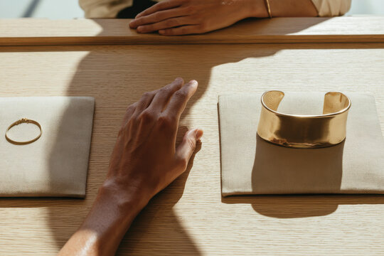 A visually appealing jewelry display featuring a gold bangle and a delicate ring, elegantly arranged to highlight form and function in modern jewelry design.