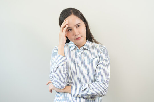 Dizzy asian young woman headache or migraine pain suffering from vertigo or sick, holding head with hand, health problem of brain or inner ear not balance, standing isolated on white background.