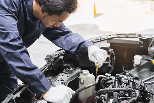 Auto check, car service shop concept. Automobile repairman work checking change engine oil, lubricant to estimate repair motor machine by engineer, mechanic inspecting maintenance at vehicle garage.