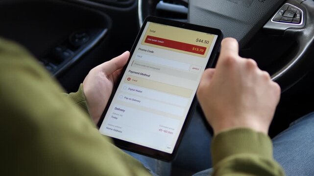 Shopper enters a promo code during tablet checkout, highlighting ecommerce discounts, digital payments, consumer savings and the frustration of an invalid coupon.
