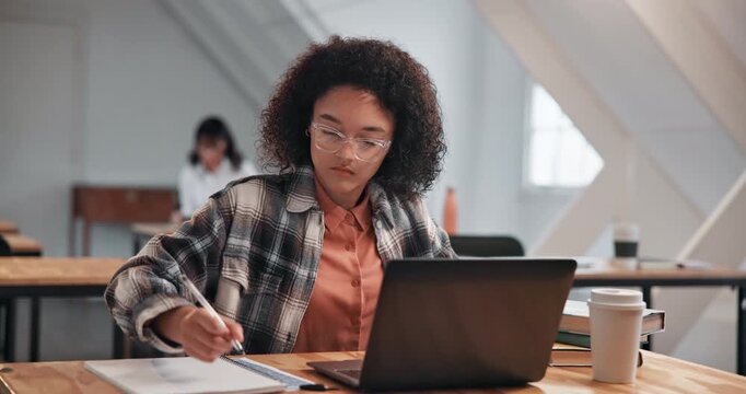 Girl, student and laptop in class with writing, information or research notes with online studying. Academic, tech or notepad in community college with typing assignment, lesson platform or education