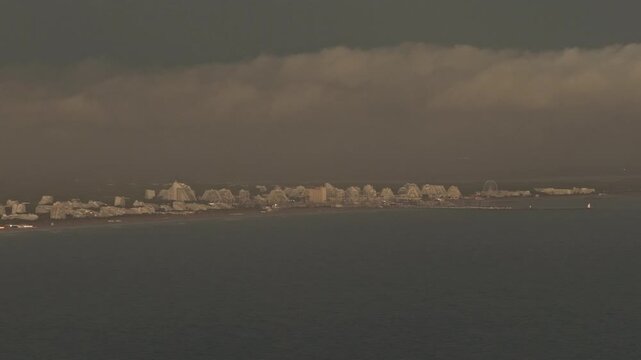 Storm clouds over pyramid resort skyline seen from the sea