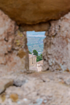 Scenic view through an ancient castle arrow slit opening