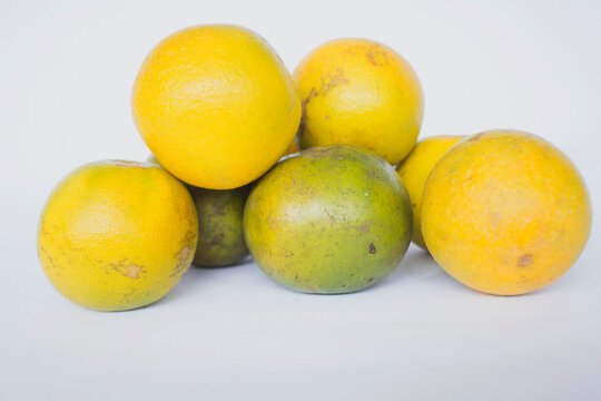 fresh lemon slice, orange slice, jeruk baby, citrus sinensis, green lemon, yellow lemon in white background