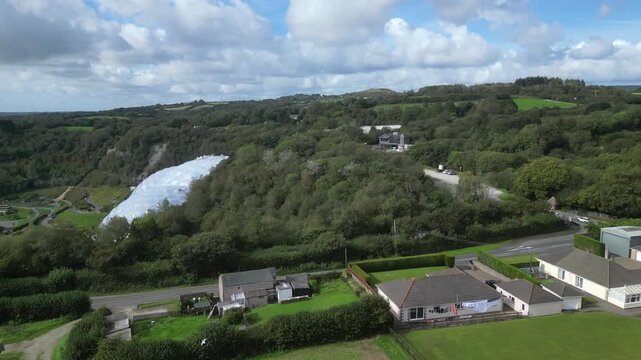 St. Blazey, Cornwall, England: DRONE VIEWS: The drone flies towards the Eden Project biomes showing the surrounding countryside. The Eden Project opened in 2001 and is a major UK tourist attraction.