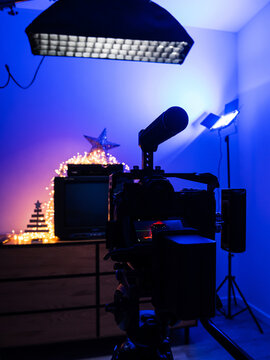 Behind the scenes of video production with mirrorless camera, studio lights and retro television setup for content creation