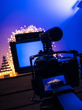 Behind the scenes of video production with mirrorless camera, studio lights and retro television setup for content creation
