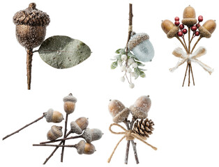 A collection of decorative frosted acorn floral picks accented with berries, pinecones, and seasonal ribbon. © z_to_the_top
