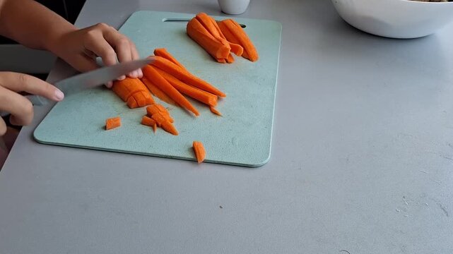 Chopping carrots in the kitchen on a cutting board