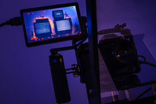 Mirrorless camera rig filmed through teleprompter glass with external monitor