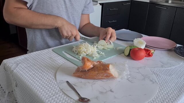 Chopping onions and preparing ingredients in a kitchen