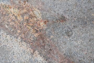 Detailed view of a brown and grey granite slab surface showing intricate, earth-toned grain patterns and speckled textures. © Ink N Propeller