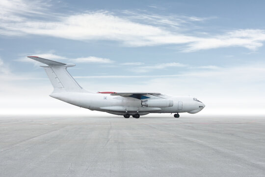White wide body transport cargo jet plane isolated on bright background with sky