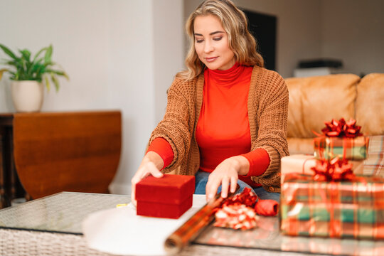Wrapping gifts in a cozy living room during the holiday season