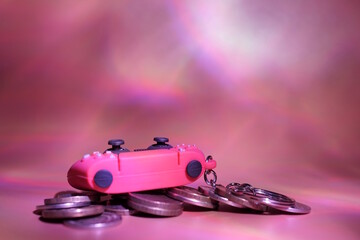 A toy game joystick with coins on a purple background. © Станислав 