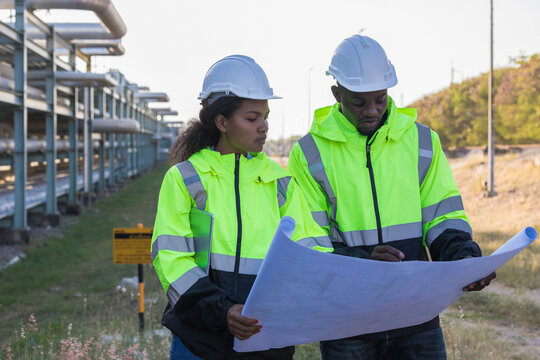 Engineer survey team checking construction project inspection work construction site .Team Civil engineer working outdoor next to the power plant.