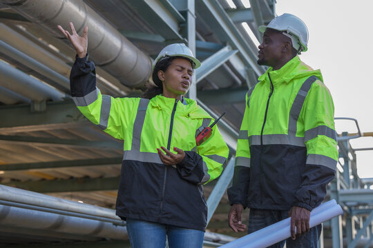 Engineer survey team checking construction project inspection work construction site .Team Civil engineer working outdoor next to the power plant.