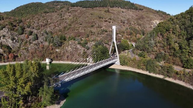 Cable-stayed bridge spanning a green Loire gorge reservoir