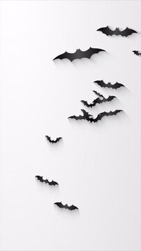 Minimalist black paper bats flying on a plain white background.