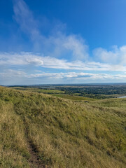 Fototapeta premium Rolling Green Hills and Dramatic Blue Sky in Ukrainian Countryside