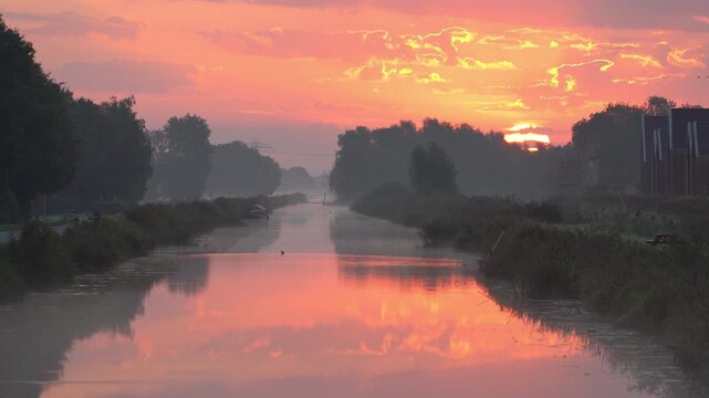 A tranquil, foggy dawn over a canal in the countryside. Meerstad, the Netherlands.