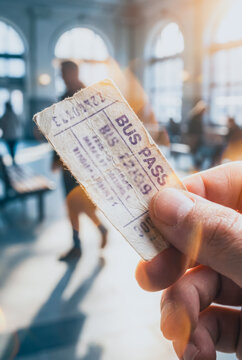 Close-up of a person holding a vintage bus pass